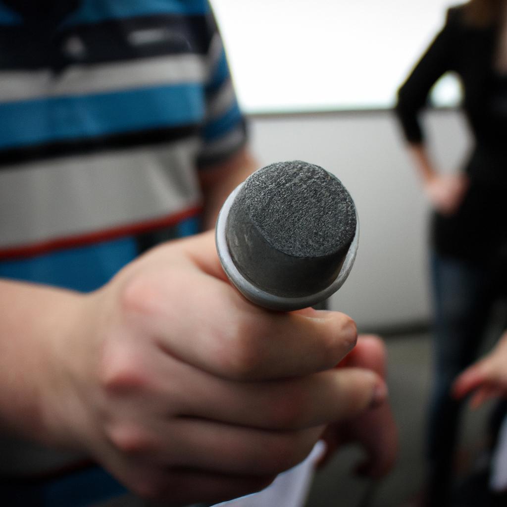 Person holding a microphone, interviewing